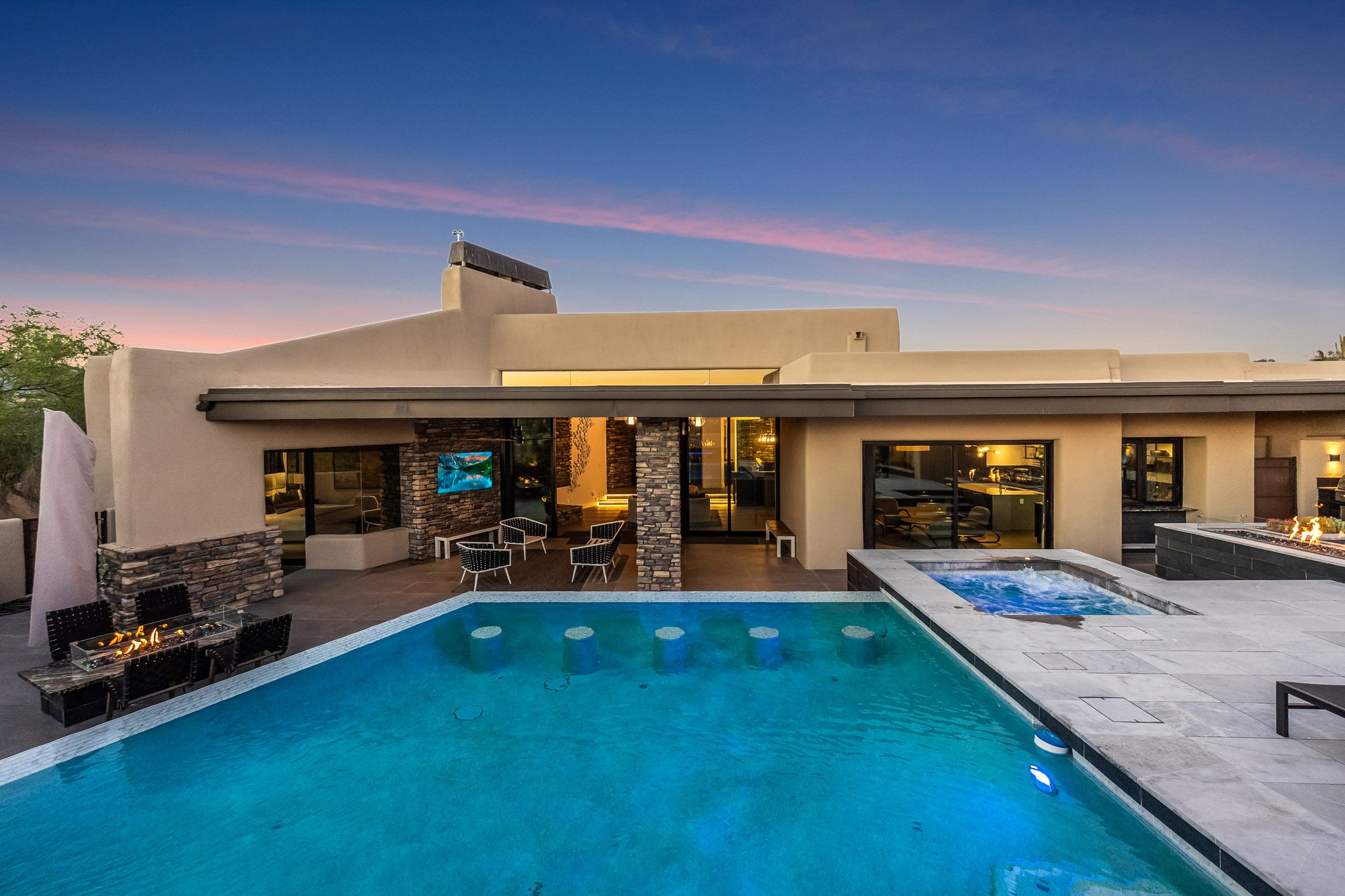 Rear of home at twilight, glowing interior