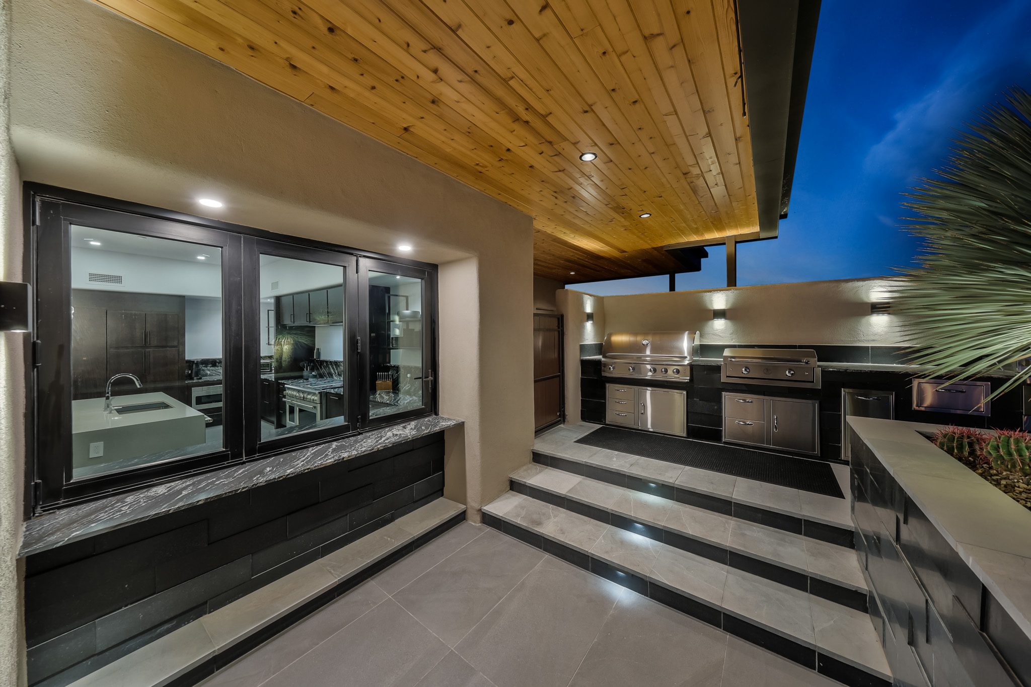 Outdoor kitchen with dual built-in BBQ