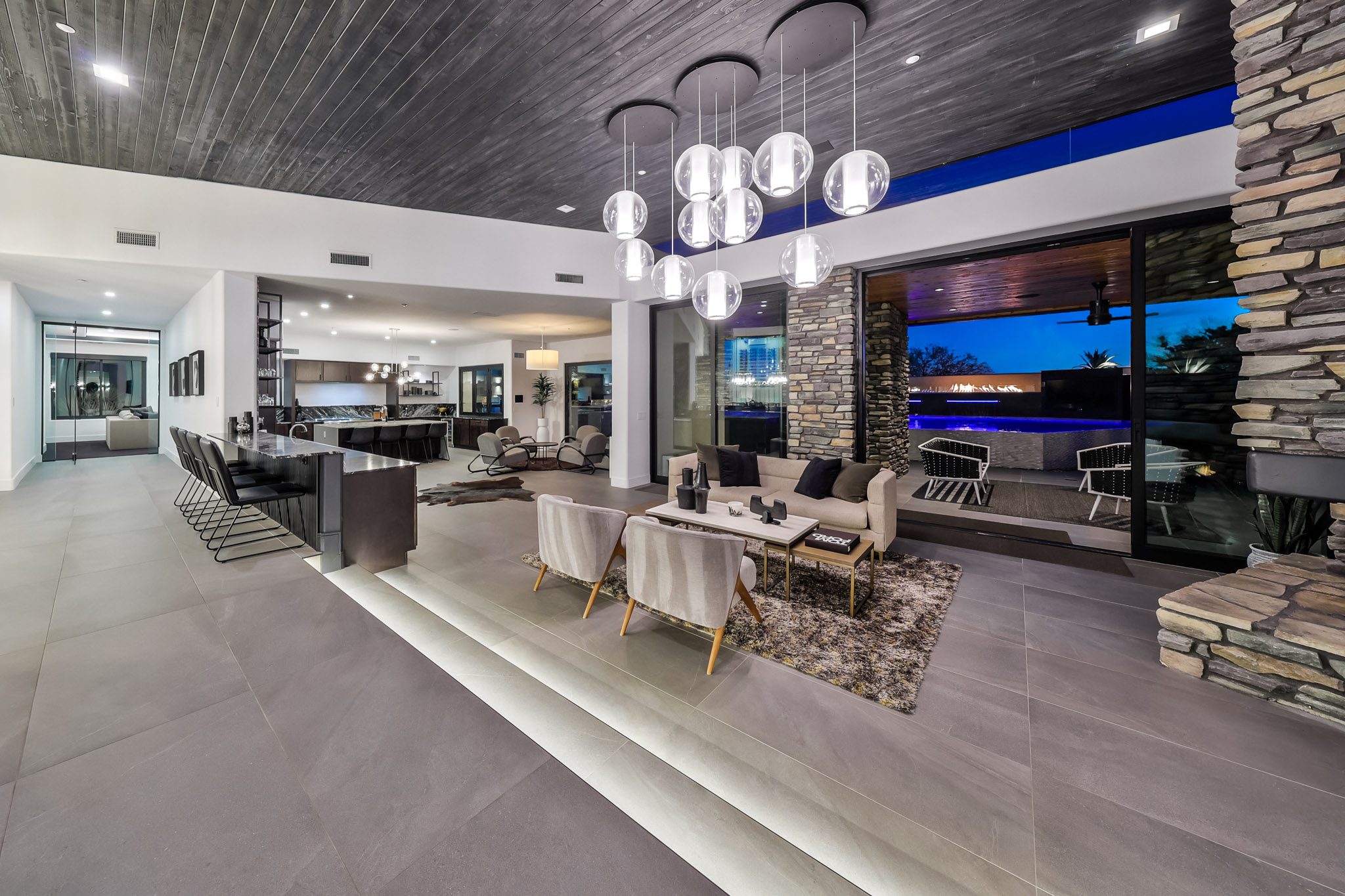 Great room view to twilight pool through glass walls